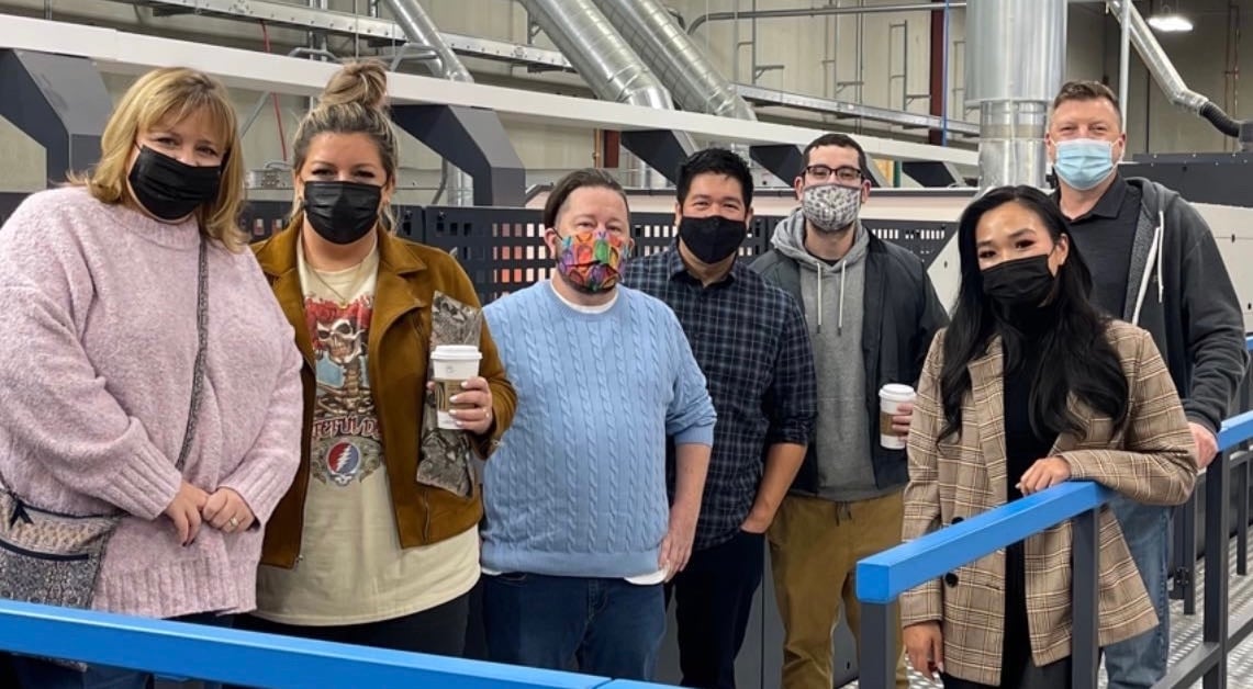 Fantastapack Team wearing masks in front of digital print press