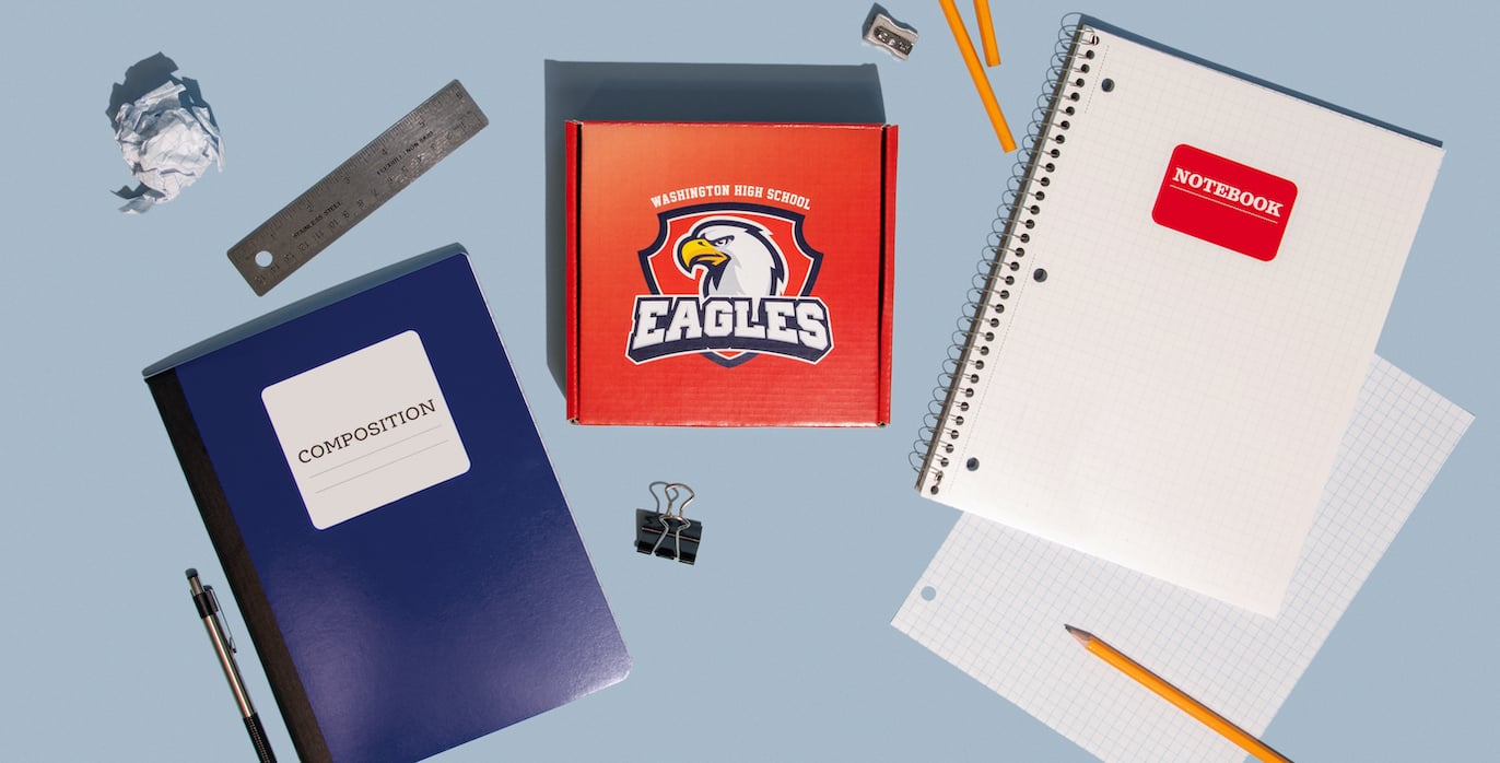 Custom school box kit with notebooks on desk